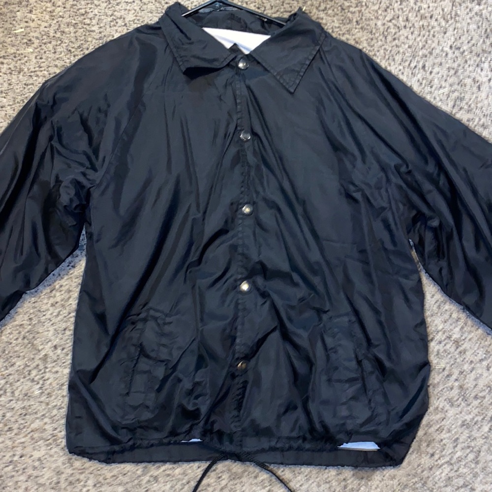 Black windbreaker with white fuzz inside